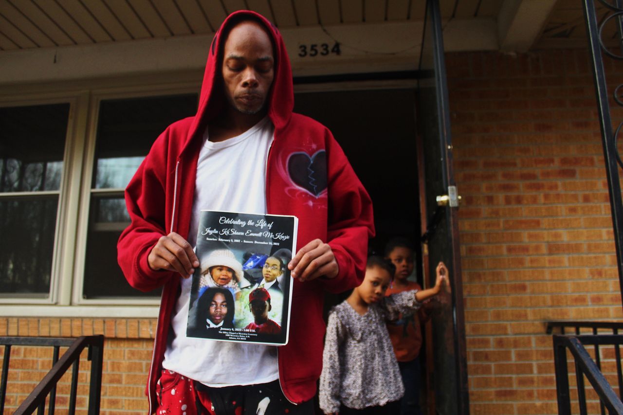 John Perry holds a program for his son, Jaylin McKenzie, who was buried just a day before Tyre Nichols died in police custody. McKenzie was fatally shot by Memphis police last year.