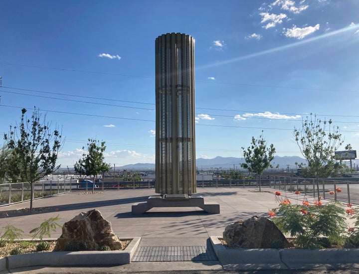 A towering memorial in the form of a giant candle to the victims of a mass shooting in El Paso, Texas, casts a shadow on Thursday, Aug. 26, 2021. The August 2019 massacre of 23 people at the adjacent Walmart store prompted many people to buy guns for personal protection. A new "constitutional carry" law in Texas allows most gun owners age 21 and older to carry a holstered handgun — concealed or not — in public without getting a license and related training. (AP Photo/Morgan Lee)