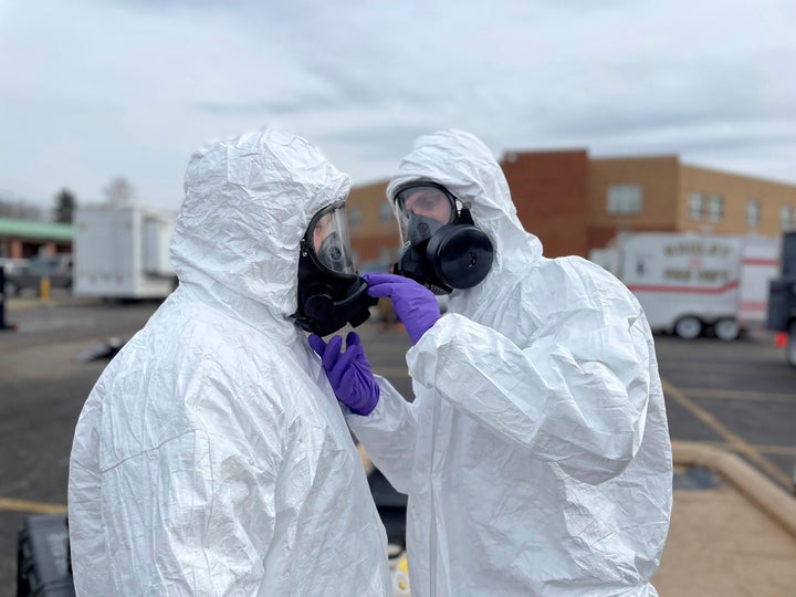 This photo provided by the Ohio National Guard, ONG 52nd Civil Support Team members prepare to enter an incident area to assess remaining hazards with a lightweight inflatable decontamination system (LIDS) in East Palestine, Ohio, on Feb. 7, 2023.