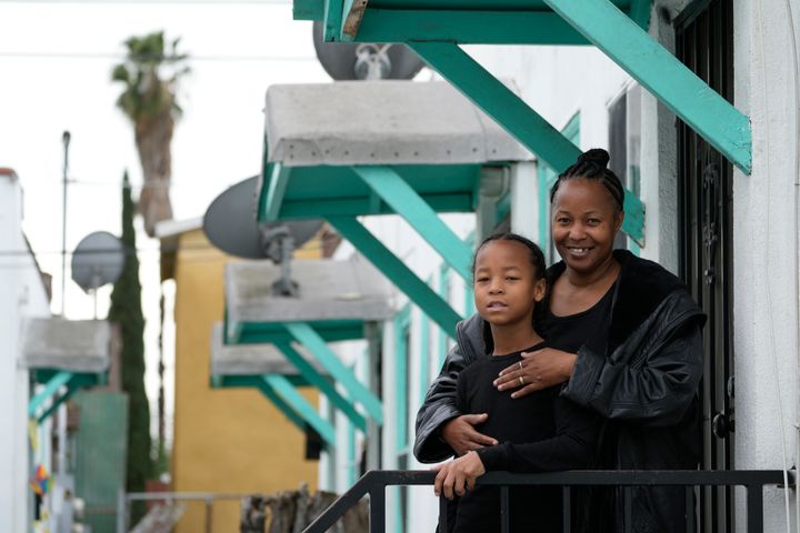 Miesha Clarke and her 10-year-old son, Ezekiel West, stand for a portrait outside their home in Los Angeles on Jan. 15, 2023. 