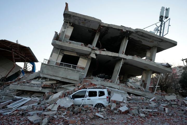 A destroyed building is seen in Aslanli, southeastern Turkey, Thursday, Feb. 9, 2023. Tens of thousands of people who lost their homes in a catastrophic earthquake huddled around campfires in the bitter cold and clamored for food and water Thursday, three days after the temblor hit Turkey and Syria. (AP Photo/Kamran Jebreili)