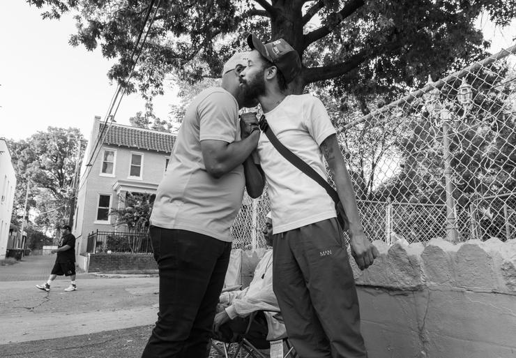 Two men give dap in a Washington neighborhood.