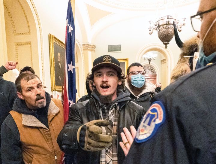 Kevin Seefried (left) and his son, Hunter Seefried, confront a U.S. Capitol Police officer on Jan. 6, 2021.