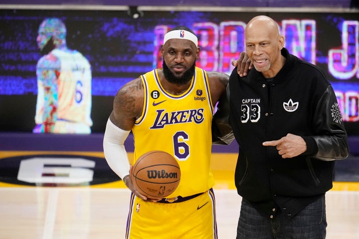 Kareem Abdul-Jabbar, left, of the Los Angeles Lakers reaches