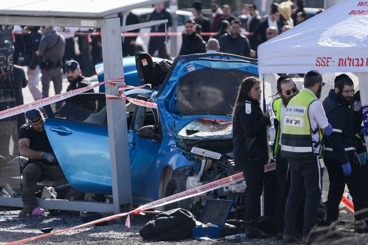 Members of Zaka Rescue and Recovery team and Israeli police forensic team work at the site of a car-ramming attack at a bus stop in Ramot, a Jewish settlement in east Jerusalem, on Feb. 10, 2023.