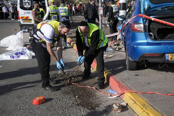 Members of Zaka Rescue and Recovery team work at the site of a car-ramming attack at a bus stop in Ramot, a Jewish settlement in east Jerusalem, on Feb. 10, 2023.