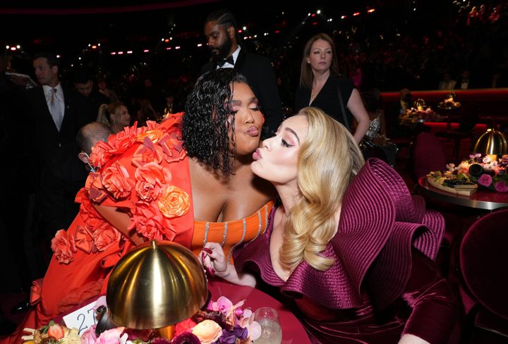 Lizzo, left, and Adele attend the Grammy Awards on Sunday in Los Angeles.