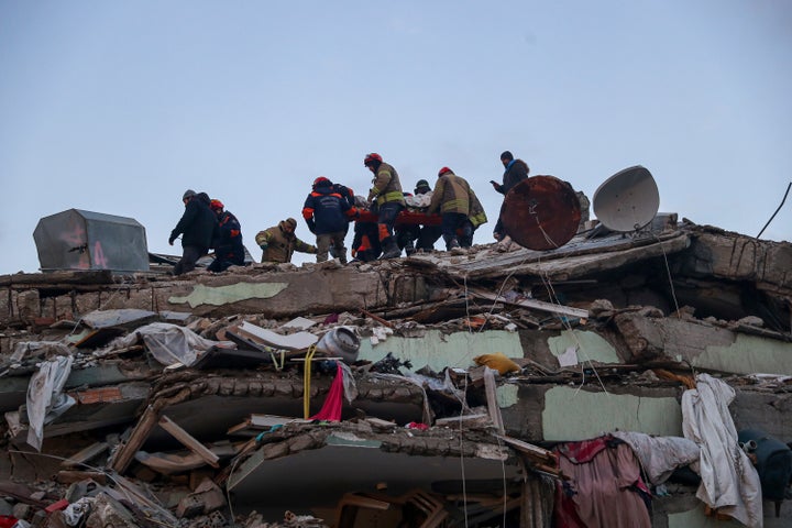 Turkish rescuers work to pull out Ergin Guzeloglan, 36, from a collapsed building five days after an earthquake in Hatay.