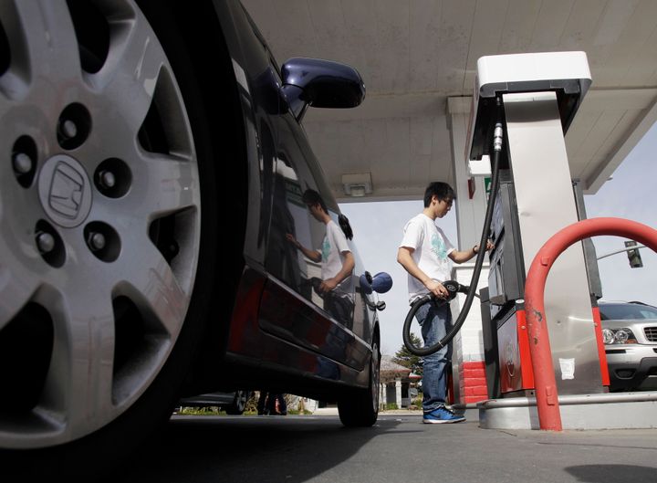 A motorist fuels up at a gas station in Santa Cruz, Calif., Monday, March 7, 2011.