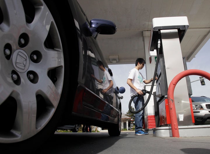 A motorist fuels up at a gas station in Santa Cruz, Calif., Monday, March 7, 2011.