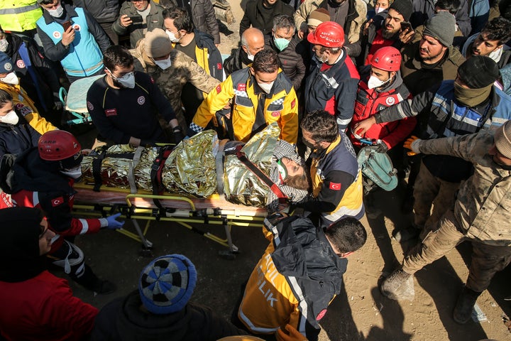 Rescuers carry Emine Murat, 40, to an ambulance after they pulled her out five days after the Monday earthquake in Adiyaman, southern Turkey, Saturday, Feb. 11, 2023. Rescuers in Turkey miraculously continued to pull earthquake survivors out of the rubble on Saturday. The unlikely rescues, coming over four days after Monday's 7.8-magnitude quake brought down thousands of buildings in Turkey and Syria, offered fleeting moments of joy amid a catastrophe that has killed nearly 24,000 people, injured at least 80,000 others and left millions homeless. (AP Photo/Emrah Gurel)