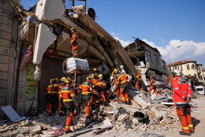 Rescue workers from Hong Kong search for survivors of the earthquake, in Antakya, Turkey, Saturday, Feb. 11, 2023. Emergency crews made a series of dramatic rescues in Turkey on Friday and Saturday, pulling several people from the rubble days after a catastrophic 7.8-magnitude earthquake killed thousands in Turkey and Syria. (AP Photo/Hussein Malla)