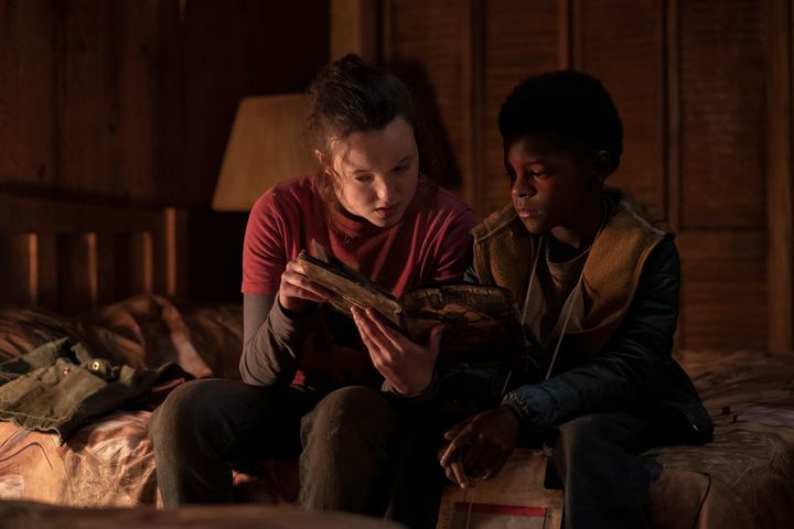 Ellie (Bella Ramsey) and Sam (Keivonn Woodard) reading a comic book together in the fifth episode of HBO's "The Last of Us."