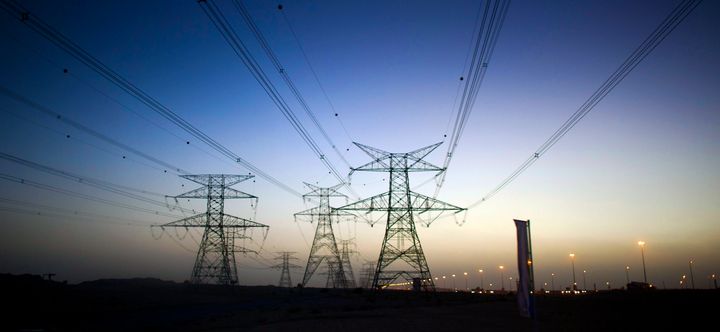 14 December 2010, Dubai U.A.E --- View of electricity pilons throughout the desert around Dubai at sunset. Photo by Victor Fraile --- Image by © Victor Fraile (Photo by Victor Fraile/Corbis via Getty Images)