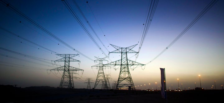 14 December 2010, Dubai U.A.E --- View of electricity pilons throughout the desert around Dubai at sunset. Photo by Victor Fraile --- Image by © Victor Fraile (Photo by Victor Fraile/Corbis via Getty Images)