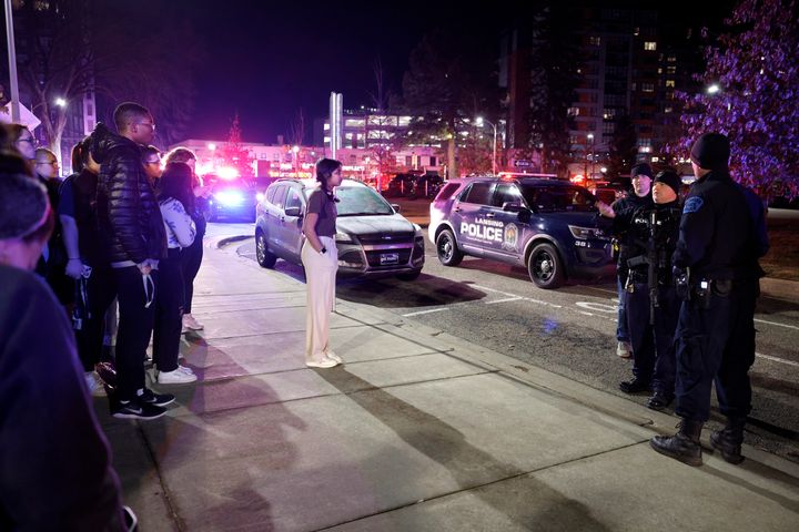 Students get directions from police on the campus of Michigan State University after a shelter in place order was lifted early on Feb. 14, 2023, in East Lansing, Mich.