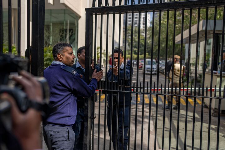Private security guards close the gate of a building housing BBC office in New Delhi, India, on Feb. 14, 2023. 