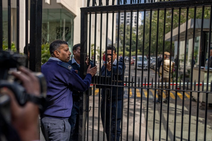 Private security guards close the gate of a building housing BBC office in New Delhi, India, on Feb. 14, 2023.