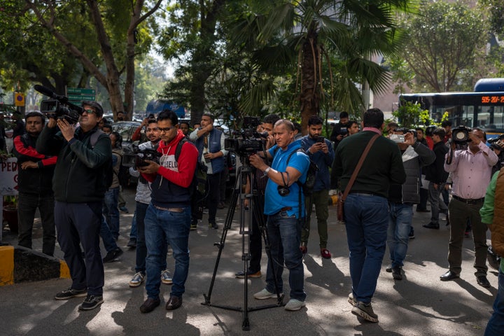 Media personnel report standing outside a building housing BBC office in New Delhi, India, on Feb. 14, 2023.