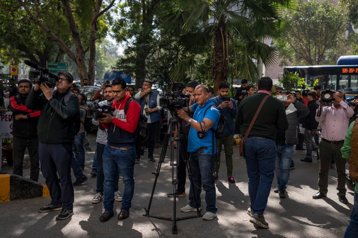 Media personnel report standing outside a building housing BBC office in New Delhi, India, on Feb. 14, 2023. 