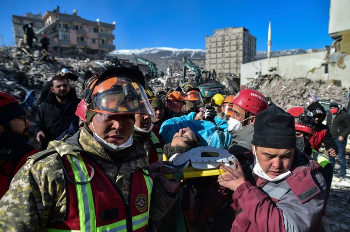Turkish rescue workers from Kazakhstan and Turkey pull out Hatice Akar from a collapsed building 180 hours after the earthquake in Kahramanmaras, southern Turkey, early Monday, Feb. 13, 2023. 