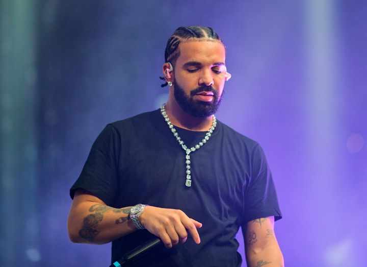 A photo of Drake performing onstage while wearing his "Previous Engagements" chain on Dec. 9, 2022, in Atlanta.
