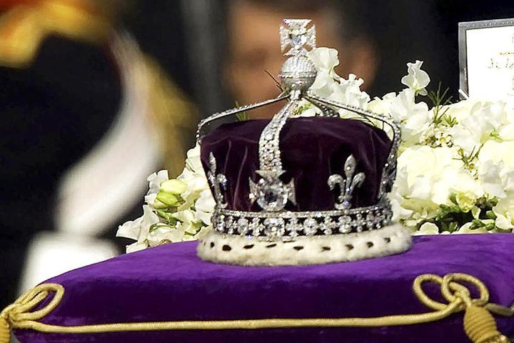 In this April 5, 2002 file photo, the Koh-i-noor, or "mountain of light," diamond, set in the Maltese Cross at the front of the crown made for Britain's late Queen Mother Elizabeth, is seen on her coffin as it is drawn to London's Westminster Hall. 
