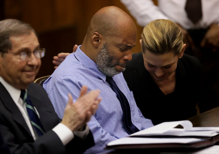 Lamar Johnson, center and his attorneys react on Tuesday, Feb. 14, 2023, after St. Louis Circuit Judge David Mason vacated his murder conviction during a hearing in St. Louis, Mo. Johnson served nearly 28 years of a life sentence for a killing that he has always said he didn't commit. (Christian Gooden/St. Louis Post-Dispatch via AP, Pool)