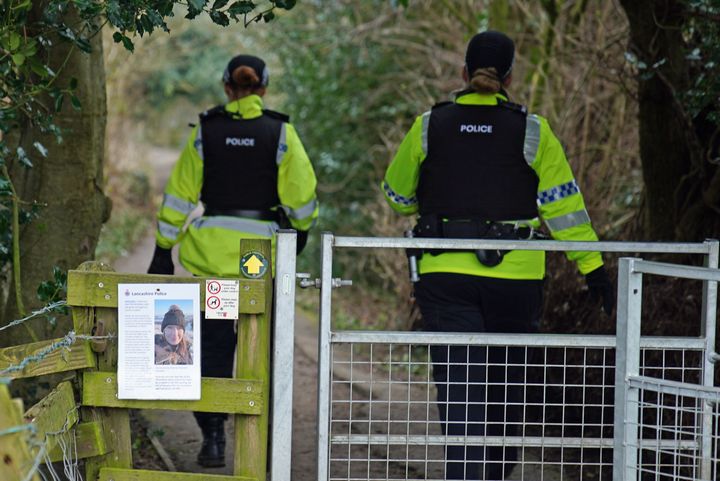 Police officers walk along a footpath in St Michael's on Wyre, Lancashire, as they continue their search for Bulley
