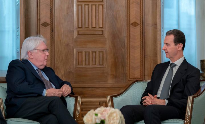 In this photo released on the official Facebook page of the Syrian Presidency, Syrian President Bashar Assad meets with Martin Griffiths, United Nations Under-Secretary-General for Humanitarian Affairs, left, in Damascus, Syria, Monday, Feb. 13, 2023. Griffiths also met with Syrian Foreign Minister Faisal Mekdad Monday to discuss ways to get aid to all parts of Syria following the deadly earthquake that hit Turkey and Syria last week.
