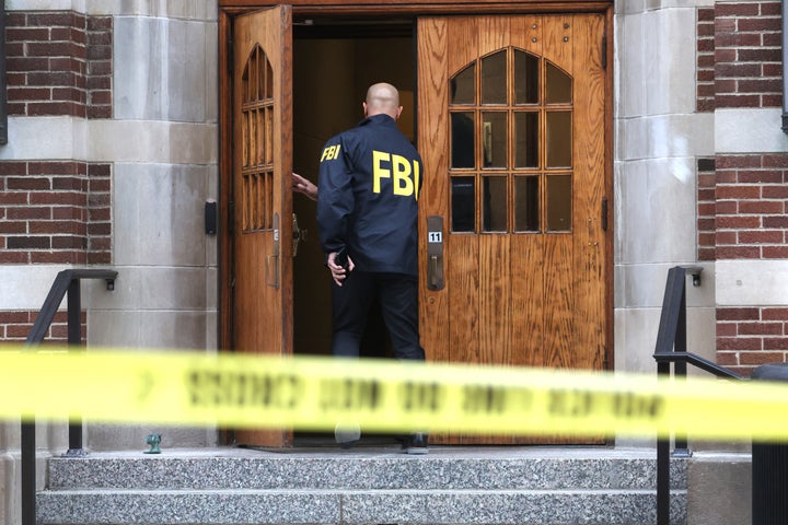EAST LANSING, MICHIGAN - FEBRUARY 16: An FBI agent enters Berkey Hall on the campus of Michigan State University on February 16, 2023 in East Lansing, Michigan. FBI agents were there to assist students and university staff in retrieving items which were left behind on February 13, when the building was evacuated after a gunman opened fire there and at another building on campus. Three students were killed and five others critically wounded. The gunman shot and killed himself a short time later during a confrontation with law enforcement officials. (Photo by Scott Olson/Getty Images)