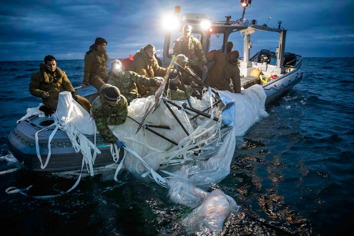 In this photo provided by the U.S. Navy, sailors assigned to Explosive Ordnance Disposal Group 2 recover a high-altitude surveillance balloon off the coast of Myrtle Beach, S.C., on Feb. 5. 