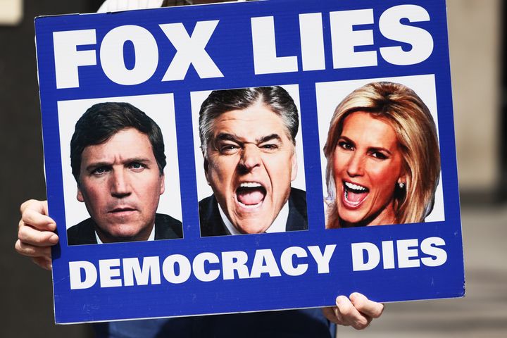 A person participating in a "Truth Tuesday" protest holds up a sign outside Fox News headquarters on June 14, 2022, in New York City.