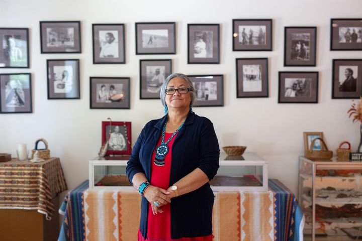 Rappahannock Tribe Chief Anne Richardson stands in front of a display of historic photos at the Rappahannock Tribal Center in Indian Neck, Virginia.