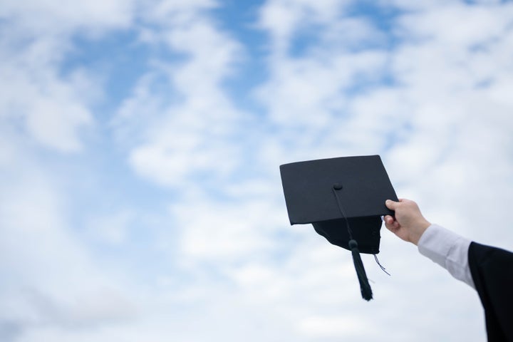 Graduate are celebrating graduation Throwing hands up a certificate and Cap in the air, Happiness cheerful feeling, Commencement, Graduation day on sky background.