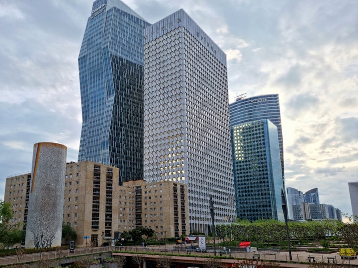 La Défense is a major business district at the City borders of Paris. The image shows several Skyscrapers on a day with cloudy sky. Captured during springtime.