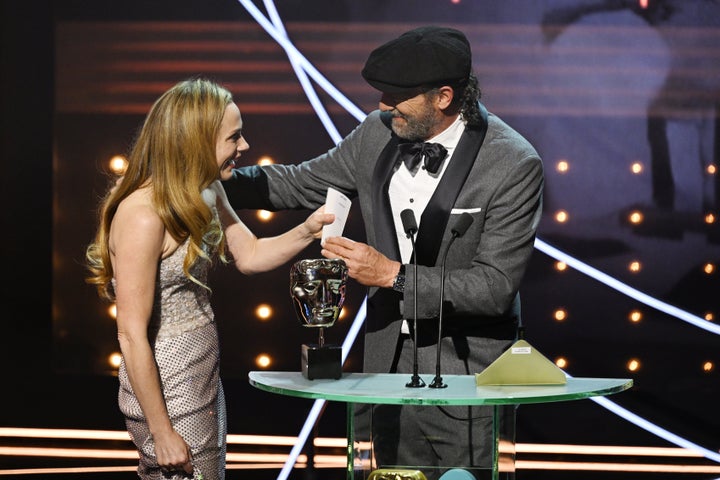 Troy Kotsur on stage with Kerry Condon during the 2023 Baftas