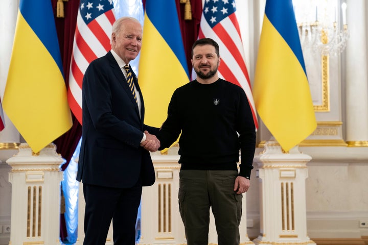 President Joe Biden, left, shakes hands with Ukrainian President Volodymyr Zelenskyy at Mariinsky Palace during an unannounced visit in Kyiv, Ukraine, on Feb. 20, 2023. 