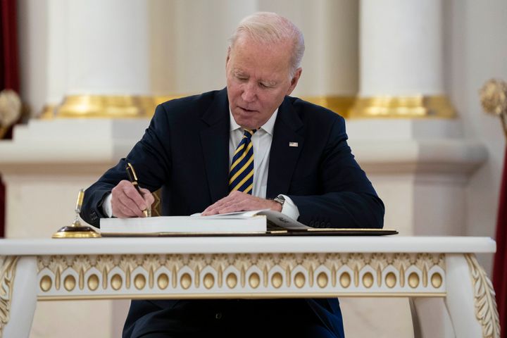 Biden signs the guest book at Mariinsky Palace.