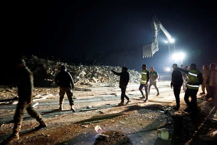 Aνθρωποι περπατούν έξω δίπλα σε ένα κτίριο που κατέρρευσε μετά από σεισμό στην Aντάκια στην επαρχία Χατάι, Τουρκία, 20 Φεβρουαρίου 2023.
