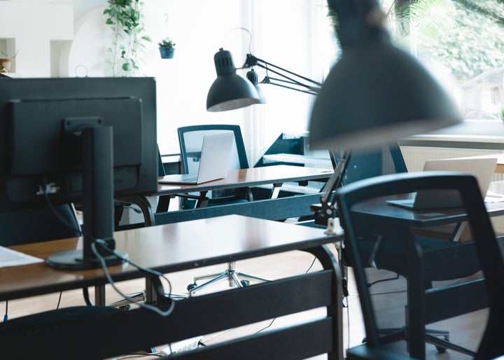 Empty open plan office with multiple work stations. Open plan office interior without people.