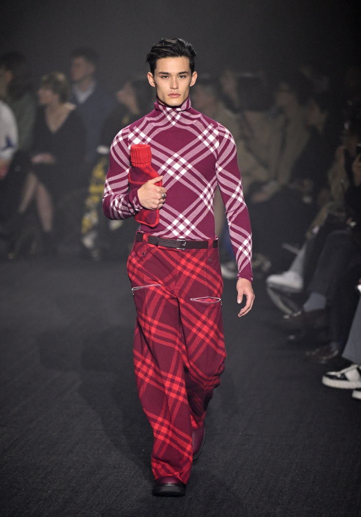 A model walks the runway -- hot water bottle case in hand -- at the Burberry show during London Fashion Week. 