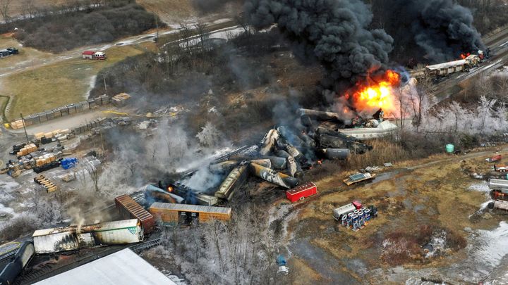 A drone image shows portions of the Norfolk Southern freight train still on fire a day after it derailed in East Palestine, Ohio. Transportation Secretary Pete Buttigieg announced a package of reforms to improve safety on Tuesday, two days after he warned Norfolk Southern to fulfill its promises to clean up the mess and help the town recover.