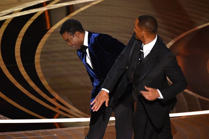 Will Smith (R) slaps Chris Rock onstage during the 94th Oscars at the Dolby Theatre in Hollywood, California on March 27, 2022. (Photo by Robyn Beck / AFP) (Photo by ROBYN BECK/AFP via Getty Images)