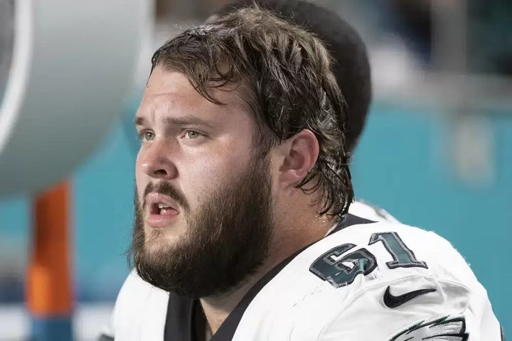 Philadelphia Eagles guard Josh Sills (61) sits on the sidelines during an NFL football game against the Miami Dolphins on Aug. 27, 2022, in Miami Gardens, Florida.