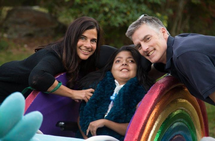 The author and her husband with 12-year-old Dalia, whose wheelchair was converted into a chariot for Halloween by Magic Wheelchair.