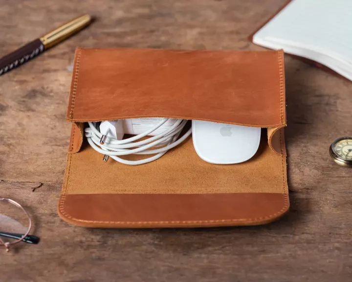 A leather Macbook charger holder from GrandiUa on Etsy
