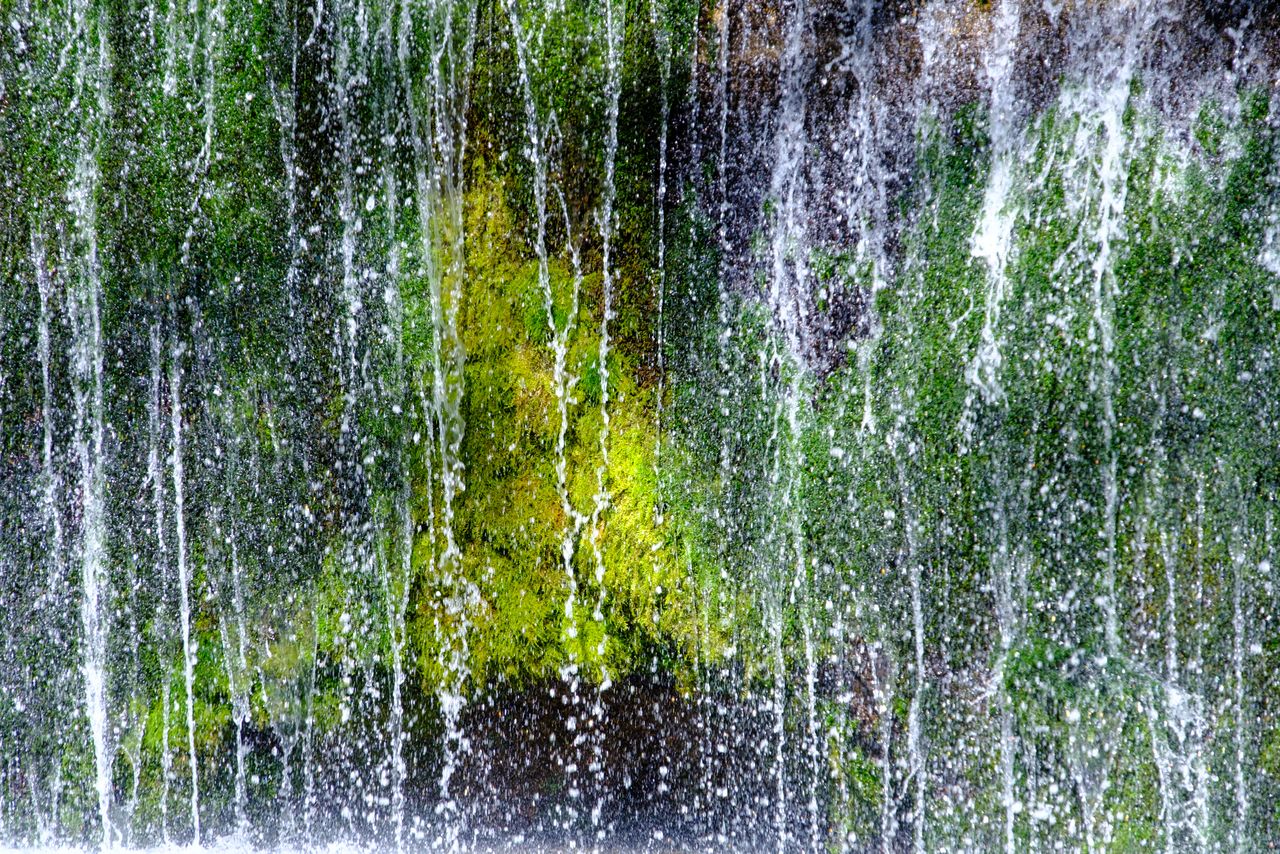 Shiraito Falls in Karuizawa is known for its veil-like water and vibrant green moss.