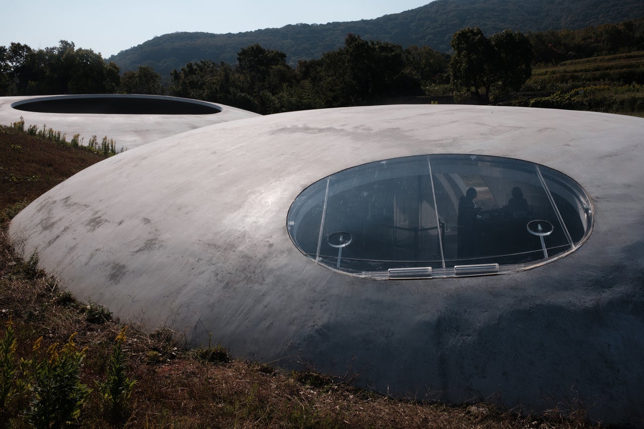 The cafe (foreground) and museum of the Teshima Art Museum, Benesse Foundation, designed by Ryue Nishizawa in Teshima.