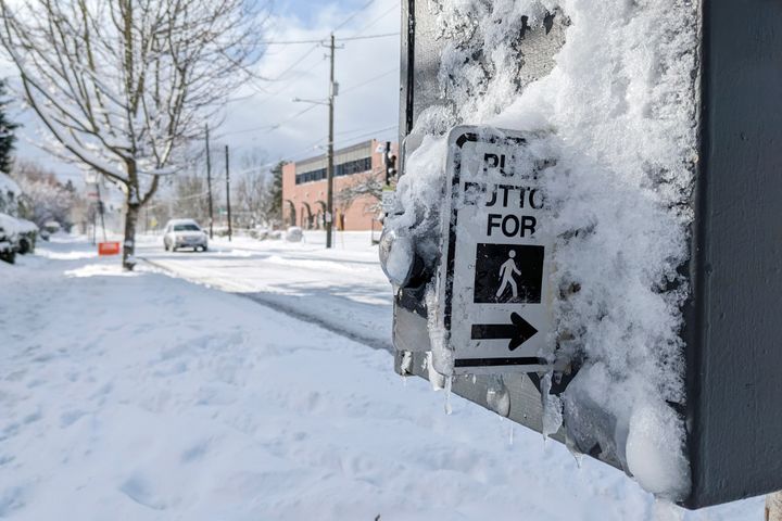 Snow and ice covers a crossing signal in the Grant Park neighborhood of Portland, Ore., Thursday Feb. 23, 2023. Winter storms sowed more chaos across the U.S. on Thursday, shutting down much of Portland after the city experienced its second snowiest day in history and paralyzing travel from parts of the Pacific Coast all the way to the northern Plains. (AP Photo/Drew Callister)